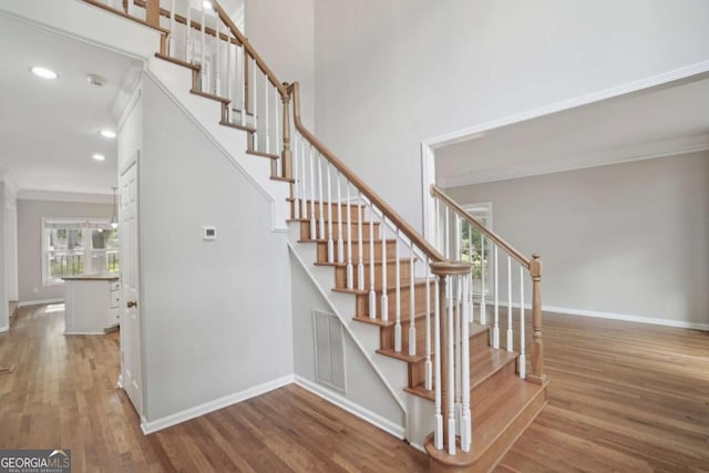 220 Chinkapin Cir SW, South Fulton, GA 30311 - staircase with wood finished floors, recessed lighting, ornamental molding, and a high ceiling