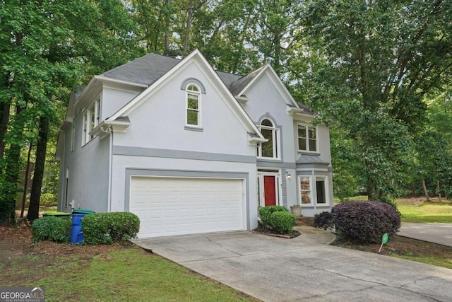 220 Chinkapin Cir SW, South Fulton, GA 30311 - traditional home featuring stucco siding, a garage, concrete driveway, and view of wooded area