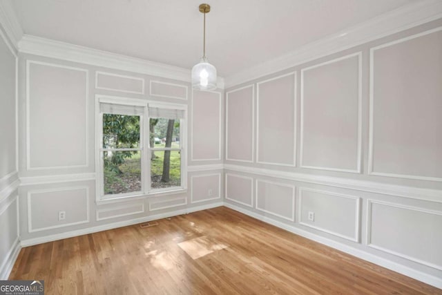 220 Chinkapin Cir SW, South Fulton, GA 30311 - unfurnished dining area with a decorative wall, crown molding, and light wood-style floors