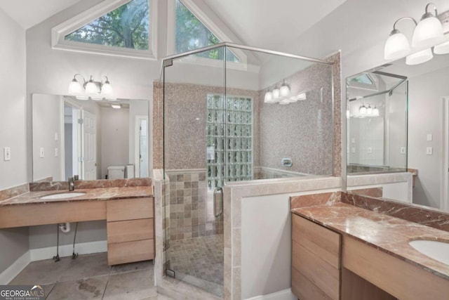 220 Chinkapin Cir SW, South Fulton, GA 30311 - full bathroom featuring lofted ceiling, tile patterned flooring, a stall shower, plenty of natural light, and vanity