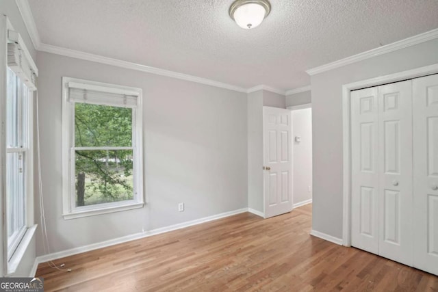 220 Chinkapin Cir SW, South Fulton, GA 30311 - unfurnished bedroom with a textured ceiling, wood finished floors, crown molding, and a closet