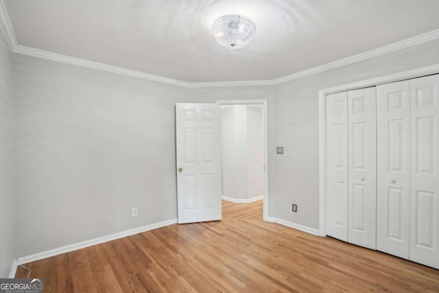 220 Chinkapin Cir SW, South Fulton, GA 30311 - unfurnished bedroom featuring ornamental molding, wood finished floors, and a closet