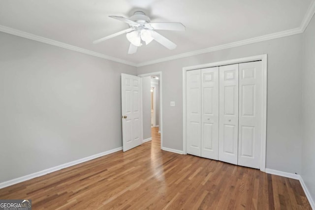 220 Chinkapin Cir SW, South Fulton, GA 30311 - unfurnished bedroom featuring wood finished floors, crown molding, a closet, and ceiling fan