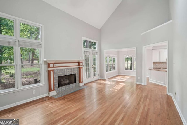 220 Chinkapin Cir SW, South Fulton, GA 30311 - unfurnished living room featuring high vaulted ceiling, light wood-style floors, and a fireplace