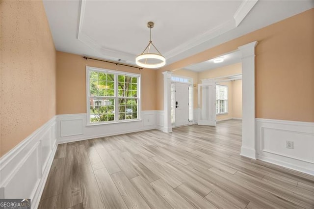 5156 Amberden Hall Dr, Suwanee, GA 30024 - unfurnished dining area featuring wainscoting, ornamental molding, healthy amount of natural light, light wood-style flooring, and a decorative wall