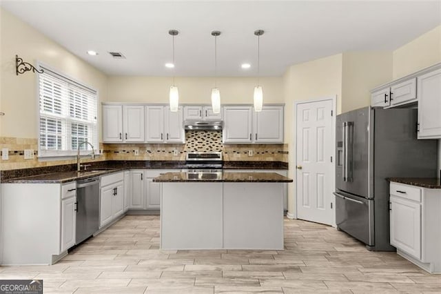 5156 Amberden Hall Dr, Suwanee, GA 30024 - kitchen featuring stainless steel appliances, under cabinet range hood, decorative backsplash, light wood finished floors, and recessed lighting