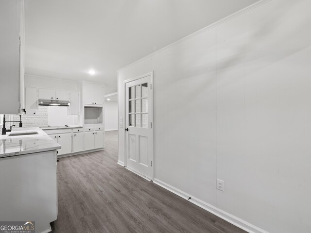 5227 Byers Rd, Gainesville, GA 30504 - kitchen featuring a sink, under cabinet range hood, white cabinets, dark wood-style floors, and light countertops