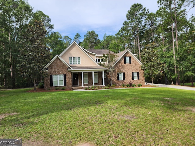 210 Plantation Trl, Statesboro, GA 30458 - craftsman-style house with a front lawn, covered porch, brick siding, and view of wooded area