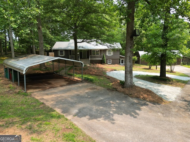 286 Barnes Cir, Commerce, GA 30530 - ranch-style home with driveway, a detached carport, covered porch, and metal roof