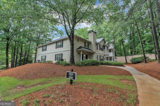 1005 Peachtree Forest Ter, Peachtree Corners, GA 30092 - view of front facade with a chimney and stucco siding