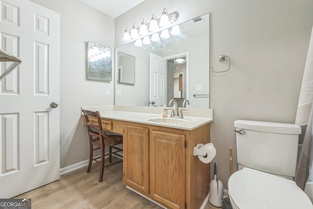 1005 Peachtree Forest Ter, Peachtree Corners, GA 30092 - bathroom with vanity, toilet, wood finished floors, and baseboards