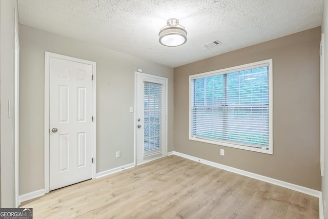 1005 Peachtree Forest Ter, Peachtree Corners, GA 30092 - empty room featuring light wood-style floors, baseboards, and a textured ceiling