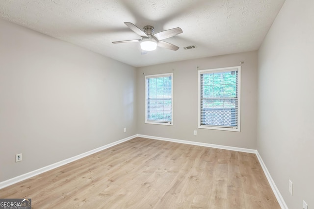1005 Peachtree Forest Ter, Peachtree Corners, GA 30092 - spare room with light wood-style floors, ceiling fan, baseboards, and a textured ceiling