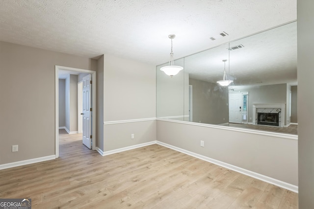 1005 Peachtree Forest Ter, Peachtree Corners, GA 30092 - unfurnished dining area with wood finished floors, baseboards, a textured ceiling, and a premium fireplace