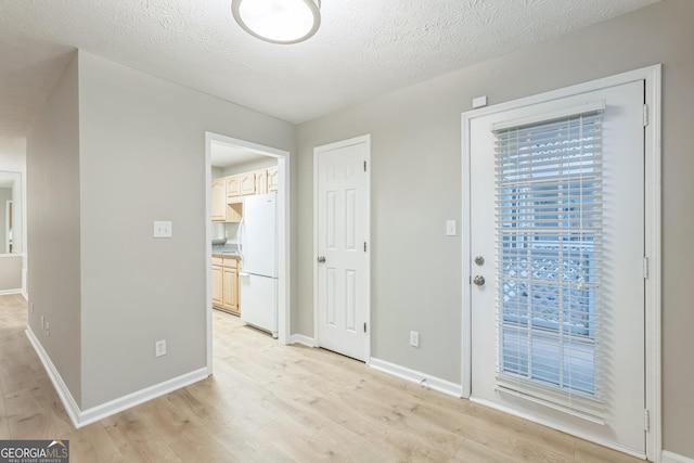 1005 Peachtree Forest Ter, Peachtree Corners, GA 30092 - unfurnished dining area featuring light wood-style flooring, baseboards, and a textured ceiling