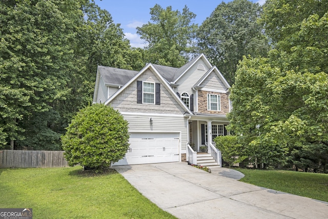 263 Chandler Ridge Dr, Douglasville, GA 30134 - view of front facade with concrete driveway, stone siding, a garage, and covered porch