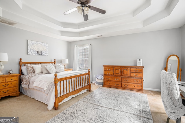 263 Chandler Ridge Dr, Douglasville, GA 30134 - bedroom featuring a tray ceiling, light colored carpet, and ceiling fan