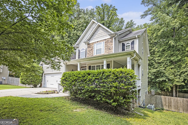 263 Chandler Ridge Dr, Douglasville, GA 30134 - view of front of house featuring concrete driveway, covered porch, stone siding, and an attached garage