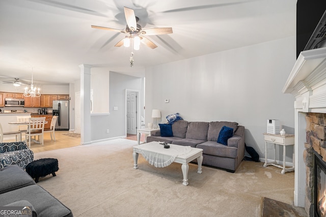 263 Chandler Ridge Dr, Douglasville, GA 30134 - living room featuring a ceiling fan, a fireplace, light carpet, and a chandelier