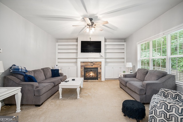 263 Chandler Ridge Dr, Douglasville, GA 30134 - living room featuring plenty of natural light, light carpet, a stone fireplace, and a ceiling fan