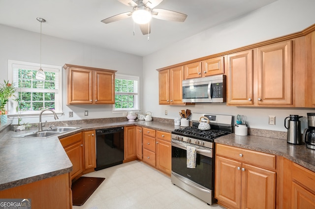 263 Chandler Ridge Dr, Douglasville, GA 30134 - kitchen featuring appliances with stainless steel finishes, dark countertops, a ceiling fan, pendant lighting, and light floors