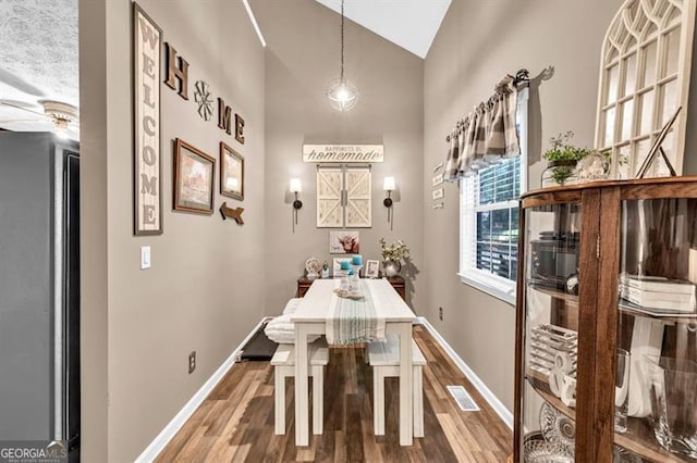 6504 Samoa, Flowery Branch, GA 30542 - dining space with wood finished floors, baseboards, high vaulted ceiling, and a ceiling fan