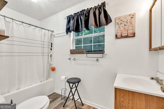 6504 Samoa, Flowery Branch, GA 30542 - bathroom featuring wood finished floors, vanity, toilet, shower / tub combo, and a textured ceiling