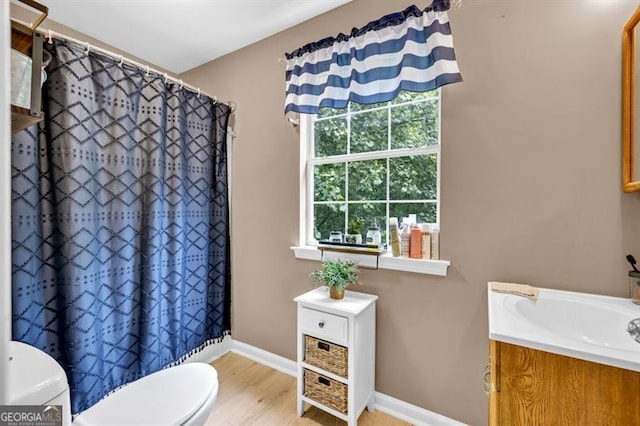 6504 Samoa, Flowery Branch, GA 30542 - full bathroom with toilet, vanity, wood finished floors, baseboards, and a shower with curtain