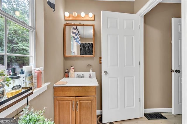 6504 Samoa, Flowery Branch, GA 30542 - bathroom with vanity, healthy amount of natural light, and baseboards