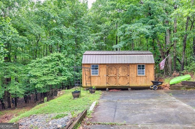 6504 Samoa, Flowery Branch, GA 30542 - view of shed featuring a wooded view
