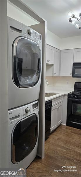 2479 Peachtree Rd NE Unit 902, Atlanta, GA 30305 - laundry room with stacked washer / dryer and dark wood finished floors