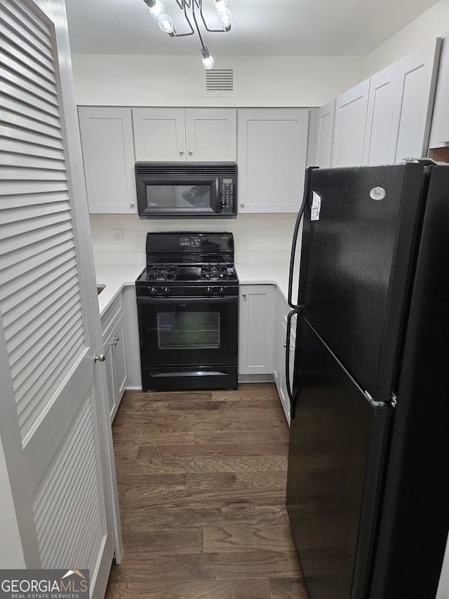 2479 Peachtree Rd NE Unit 902, Atlanta, GA 30305 - kitchen with black appliances, light countertops, and dark wood finished floors