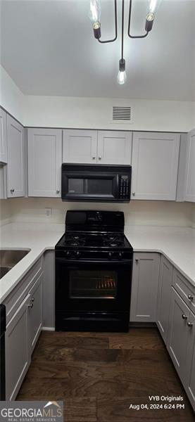 2479 Peachtree Rd NE Unit 902, Atlanta, GA 30305 - kitchen featuring black appliances, gray cabinetry, and light countertops