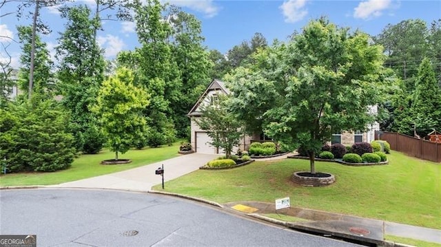 2040 Bloomfield Ct, Cumming, GA 30041 - view of property hidden behind natural elements with concrete driveway, a garage, and view of scattered trees