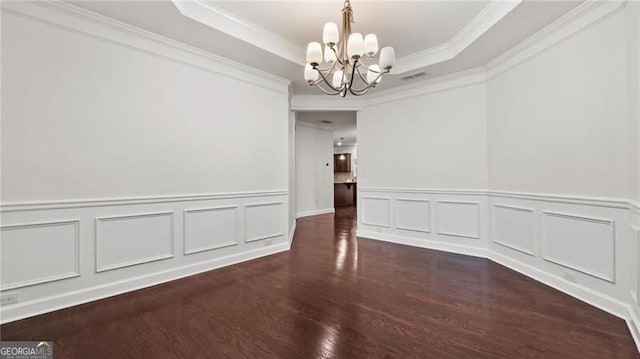 2040 Bloomfield Ct, Cumming, GA 30041 - unfurnished dining area featuring a chandelier, a raised ceiling, wood finished floors, a decorative wall, and ornamental molding