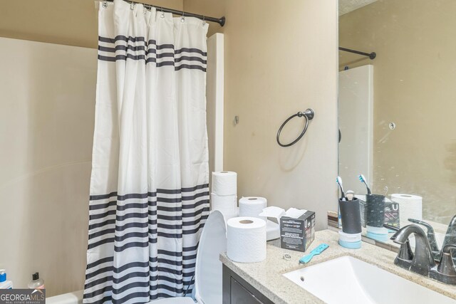 115 Glen Echo Dr, Covington, GA 30016 - bathroom featuring toilet, vanity, and shower / tub combo with curtain