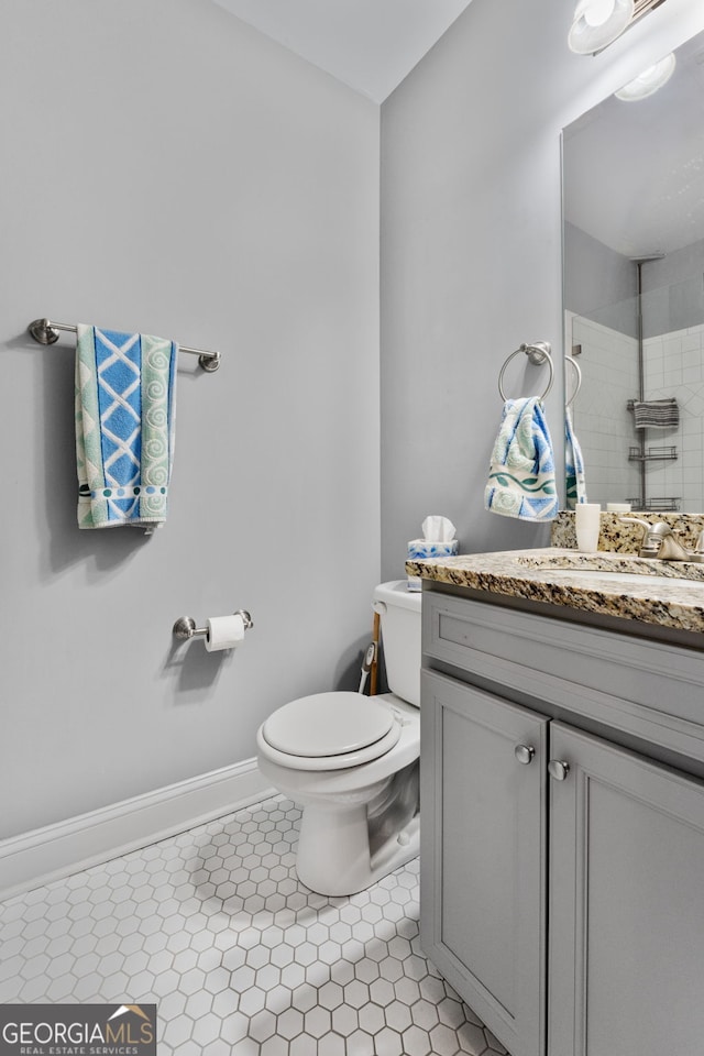 150 Crestview Rd, Jackson, GA 30233 - bathroom featuring toilet, vanity, baseboards, tiled shower, and tile patterned flooring