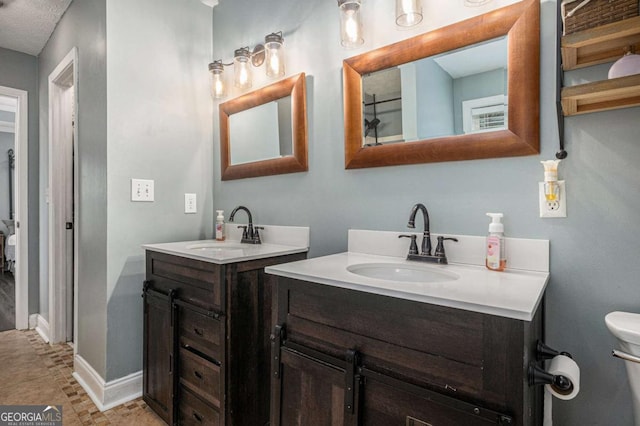 270 Meadow View Dr, Grayson, GA 30017 - full bathroom featuring two vanities, toilet, and baseboards