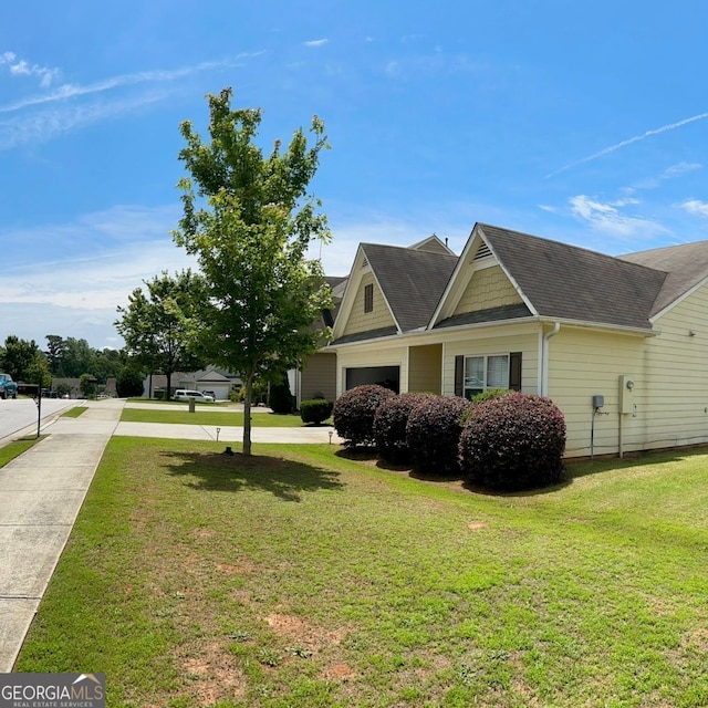 4241 Swamp Cypress Trl, Gainesville, GA 30504 - view of side of property featuring driveway, a lawn, and a shingled roof