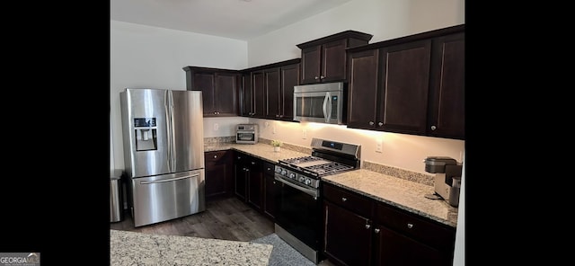 4241 Swamp Cypress Trl, Gainesville, GA 30504 - kitchen featuring appliances with stainless steel finishes, dark wood-type flooring, light stone countertops, and dark brown cabinets