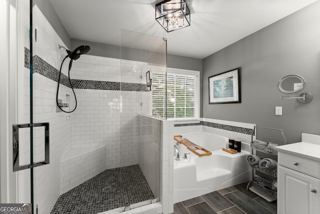 1504 Oglethorpe Dr, Suwanee, GA 30024 - bathroom with a garden tub, a shower stall, vanity, and wood finish floors