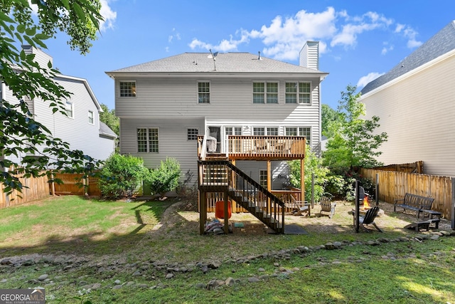 1504 Oglethorpe Dr, Suwanee, GA 30024 - back of house with a fenced backyard, stairway, a deck, and a chimney
