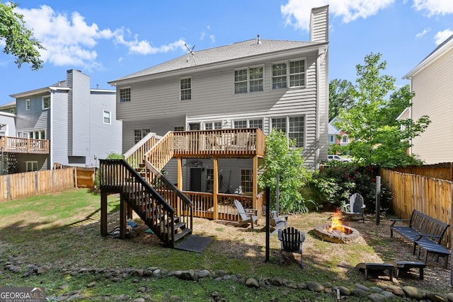 1504 Oglethorpe Dr, Suwanee, GA 30024 - back of property featuring a fire pit, stairs, a wooden deck, a fenced backyard, and a chimney