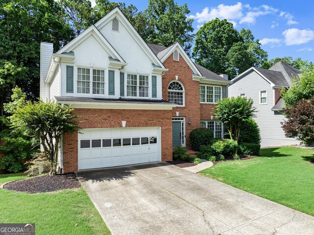 1504 Oglethorpe Dr, Suwanee, GA 30024 - view of front of house with a garage, brick siding, driveway, and a front lawn