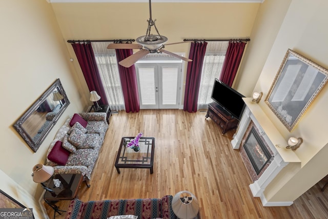 1442 Swiftwater Cir, Mcdonough, GA 30252 - living area with a glass covered fireplace, wood finished floors, french doors, and a towering ceiling