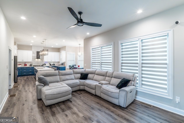 5490 Bent Grass Way, Douglasville, GA 30135 - living room with a ceiling fan, dark wood-style floors, healthy amount of natural light, a chandelier, and recessed lighting
