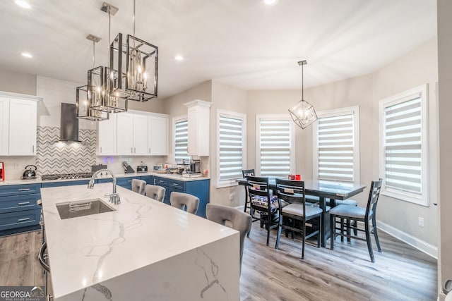 5490 Bent Grass Way, Douglasville, GA 30135 - kitchen featuring a sink, blue cabinetry, a center island with sink, white cabinetry, and recessed lighting