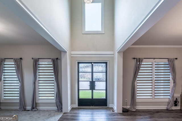 5490 Bent Grass Way, Douglasville, GA 30135 - entrance foyer featuring french doors, baseboards, crown molding, wood finished floors, and a high ceiling