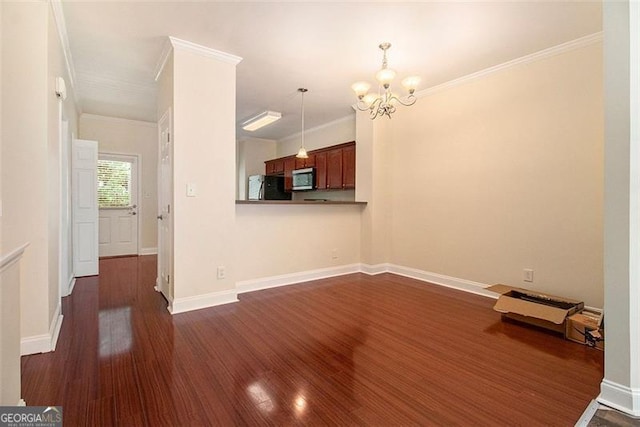 3068 Lauren Parc Rd, Decatur, GA 30032 - unfurnished living room with dark wood-style flooring, a chandelier, crown molding, and baseboards