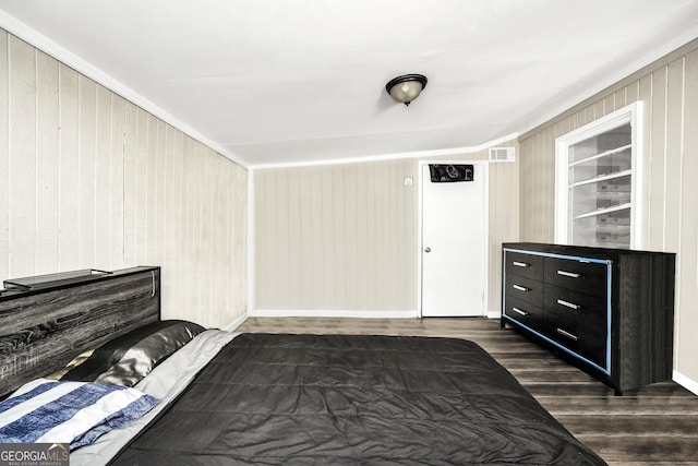 106 Vickie Dr, Warner Robins, GA 31093 - bedroom with dark wood-style flooring and wood walls